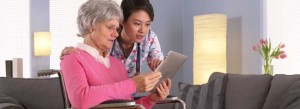 caregiver and older female looking at document